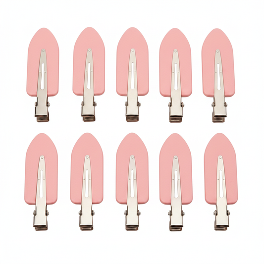 Pink hair clips on white background